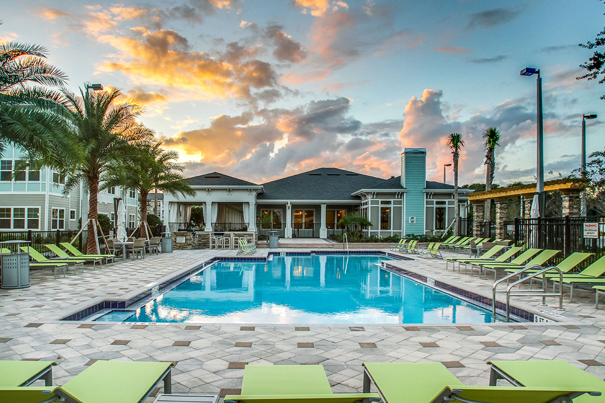 Pool surrounded by green lounge chairs